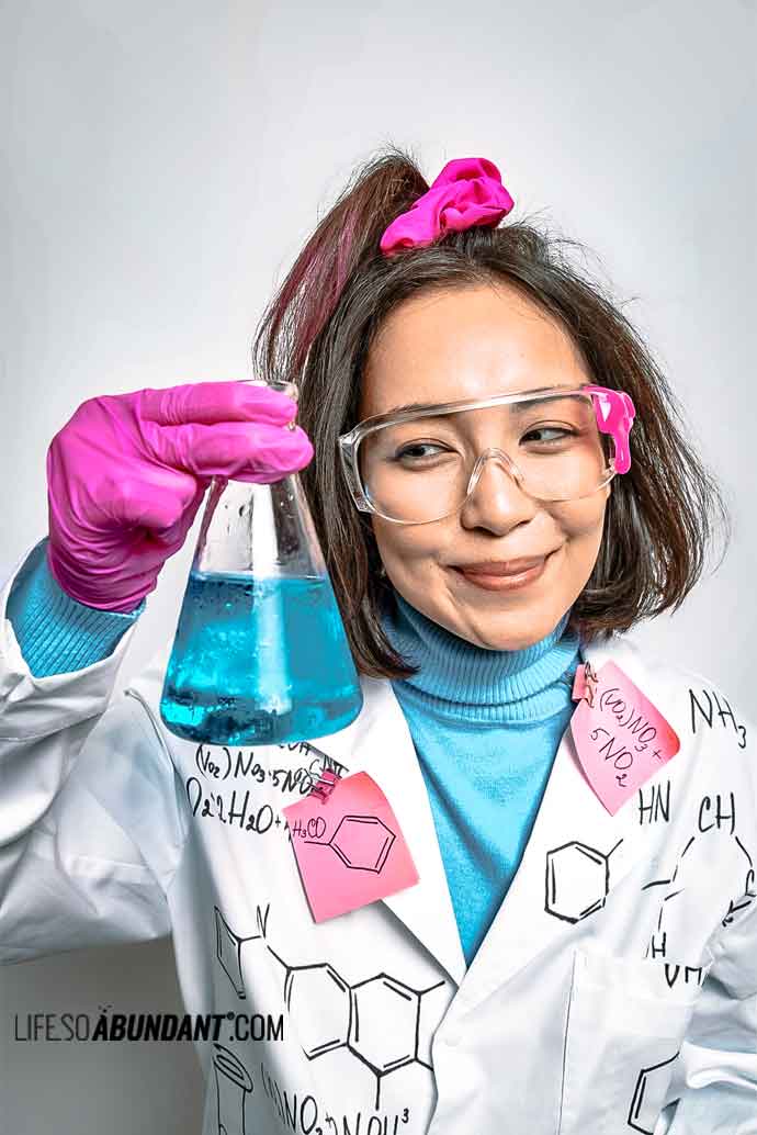 Satisfied Woman Chemist Holding Lab Glassware - Life So Abundant®